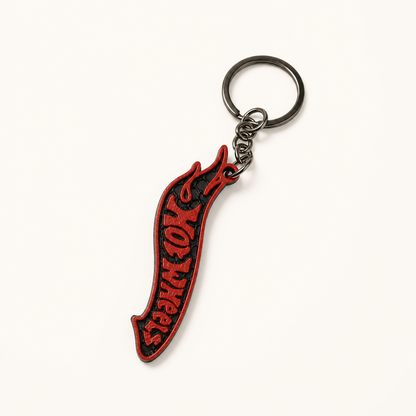 Red and black racing flame keychain on a white studio background