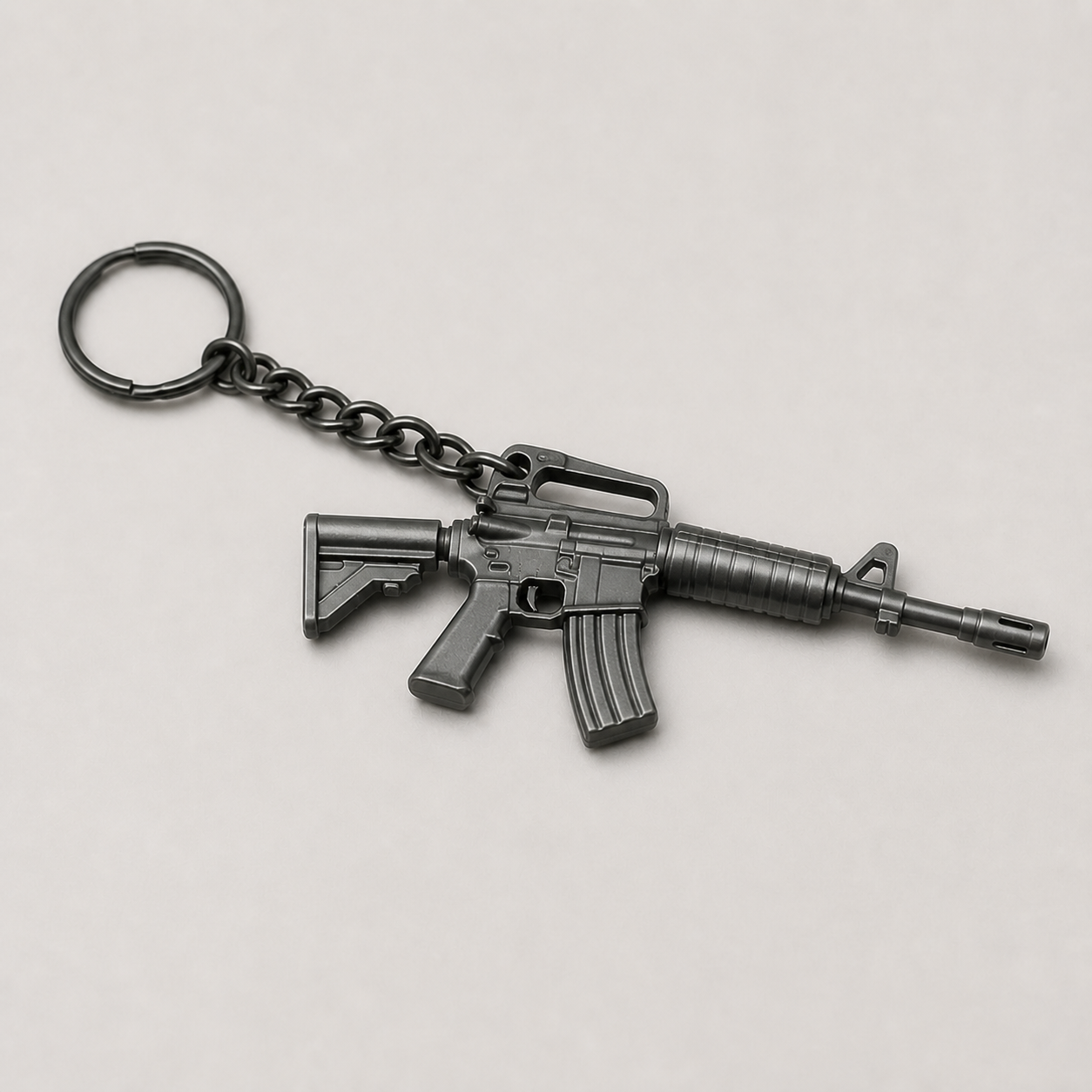 Black tactical rifle miniature keychain shown from an alternate studio angle