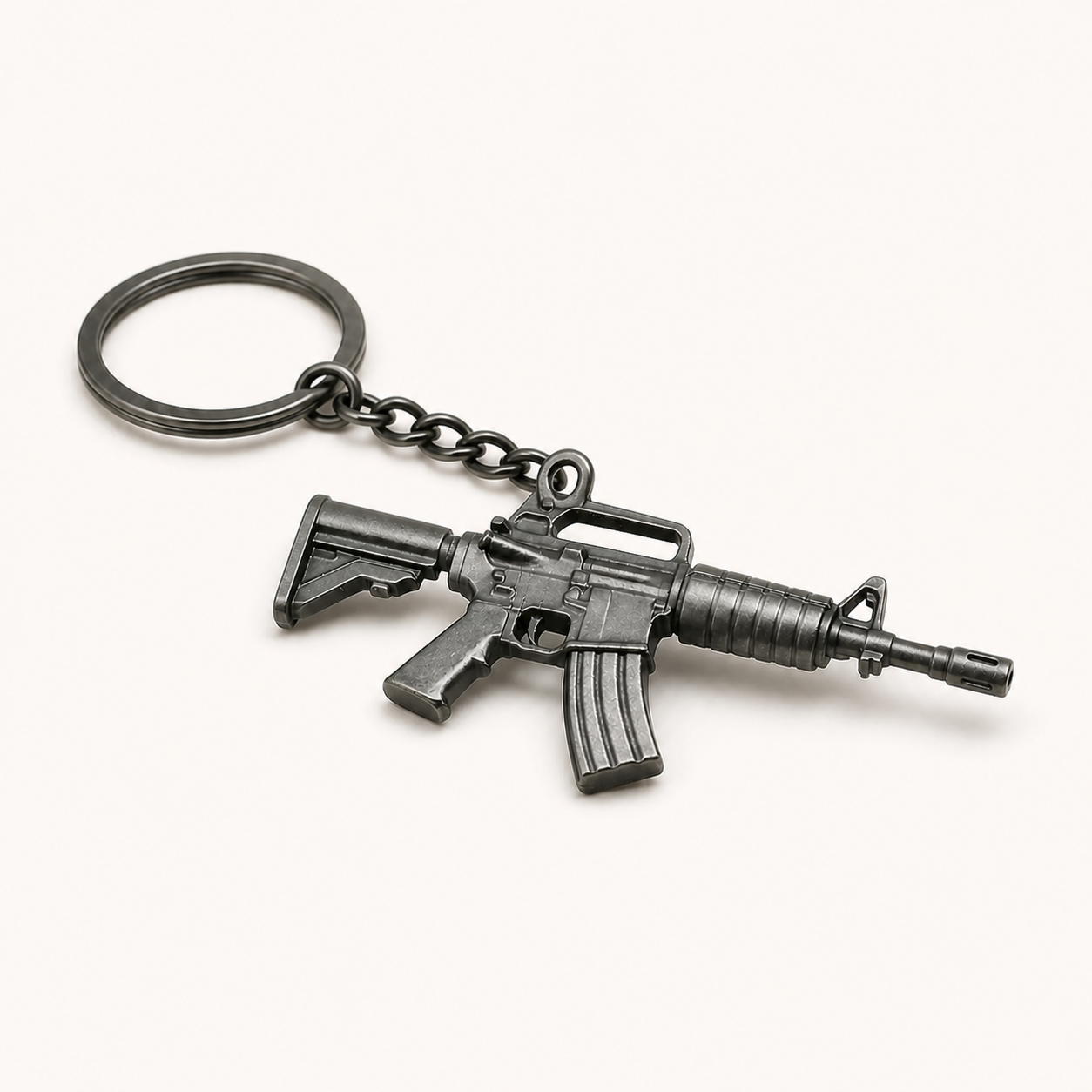 Black tactical rifle miniature keychain on a white studio background