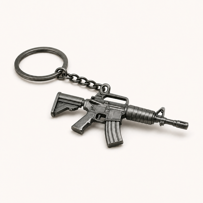 Black tactical rifle miniature keychain on a white studio background